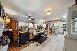Living room with a chandelier and a ceiling fan