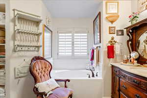 Full bathroom with vanity and a garden tub