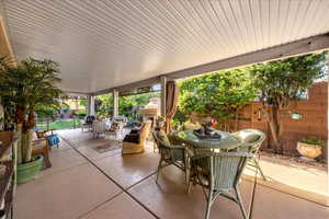 Fenced backyard with outdoor dining space and a patio area