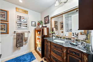 Bathroom with vanity and wood finished floors