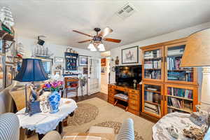 Living room featuring french doors and a ceiling fan