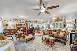 Living area featuring a chandelier and ceiling fan