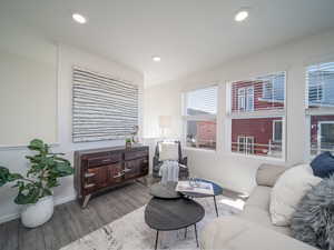 Living area featuring laminate wood floors and recessed lighting