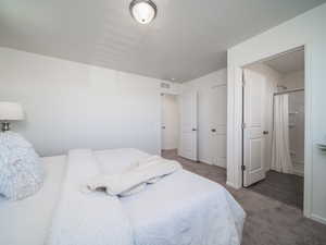 Bedroom featuring carpet and baseboards