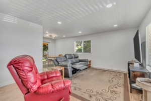 Living area with recessed lighting, baseboards, and wood finished floors