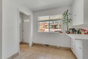 Unfurnished dining area featuring baseboards and light tile patterned floors