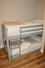 Bedroom featuring wood finished floors and baseboards