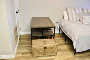 Bedroom featuring light wood-style floors and baseboards
