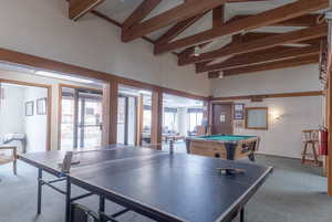 Playroom featuring carpet, high vaulted ceiling, beam ceiling, and pool table