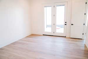 Empty room featuring light wood-style flooring and baseboards