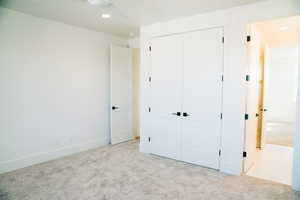 Unfurnished bedroom with carpet flooring, recessed lighting, a closet, and baseboards