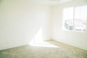Empty room with carpet flooring and baseboards