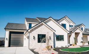View of front of house featuring stone siding, concrete driveway, an attached garage, stucco siding, and a tiled roof