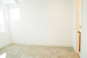 Unfurnished room with carpet and baseboards