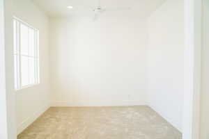Spare room with light colored carpet, baseboards, ceiling fan, and recessed lighting