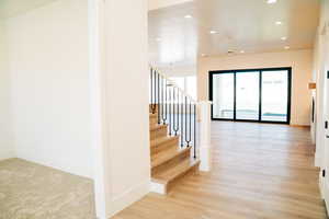 Staircase featuring recessed lighting, baseboards, and wood finished floors