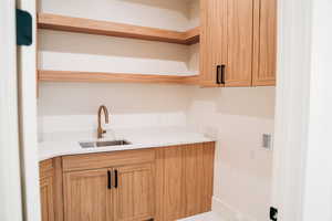 Laundry area with cabinet space and hookup for a washing machine