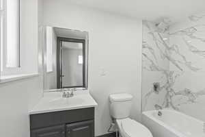 Bathroom with vanity, toilet, and bathtub / shower combination
