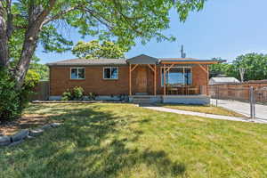 Ranch-style home featuring brick siding and covered porch