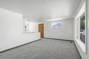Spare room featuring carpet, baseboards, and recessed lighting