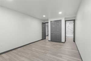 Unfurnished bedroom with baseboards, recessed lighting, and light wood-style floors
