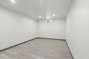 Unfurnished room featuring recessed lighting, light wood-style flooring, and baseboards