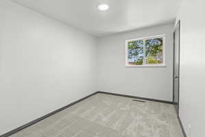 Empty room with carpet flooring and baseboards