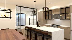 Kitchen with black microwave, a sink, stainless steel range, decorative backsplash, and light wood-style floors
