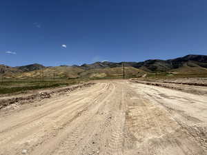 View of dirt / gravel road featuring a mountain view and a rural view