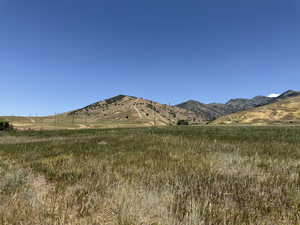 View of mountain background featuring rural landscape