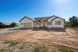 View of front facade with driveway and an attached garage