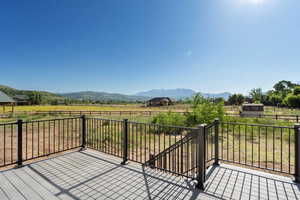 Deck featuring a view of countryside and a mountain view