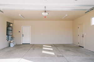 Garage with water heater and baseboards