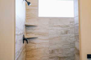 Full bathroom featuring a tile shower