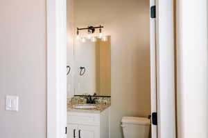 Half bathroom with toilet and vanity