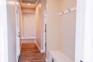 Mudroom with wood finished floors and baseboards