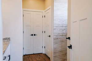 Doorway to outside featuring dark wood-style flooring