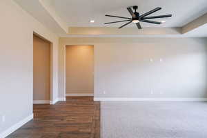 Unfurnished room featuring a ceiling fan, baseboards, dark wood finished floors, and recessed lighting