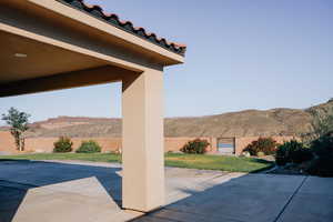 Fenced backyard with a mountain view and a patio area