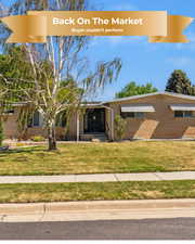 View of front of property with brick siding and a front lawn