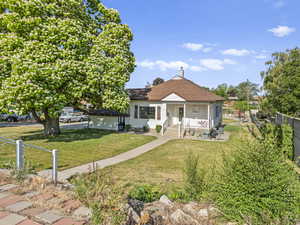 Bungalow-style house featuring covered porch and a shingled roof