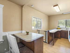 Office space with light wood finished floors and a sink