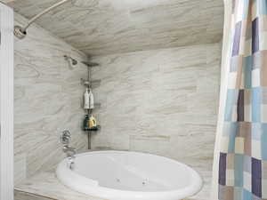 Bathroom with a combined bath / shower with jetted tub