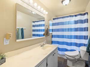 Bathroom with vanity, tile patterned flooring, and a shower with curtain