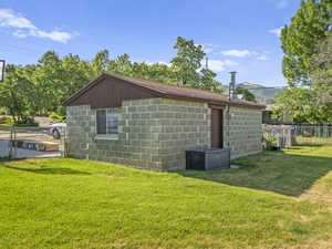 View of side of home featuring concrete block siding