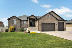 View of front facade featuring driveway, a garage, brick siding, and roof with shingles