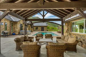 View of patio / terrace featuring a gazebo, an outdoor hangout area, a hot tub, an outdoor pool, and a grill