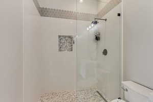 Full bathroom with toilet and a walk in shower