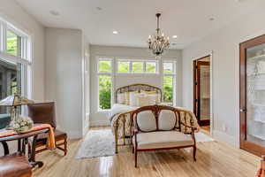 Bedroom with multiple windows, baseboards, a chandelier, and recessed lighting