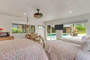 Bedroom featuring access to outside, multiple windows, and recessed lighting
